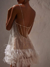 Robe courte dos nu en maille à pampilles Marie